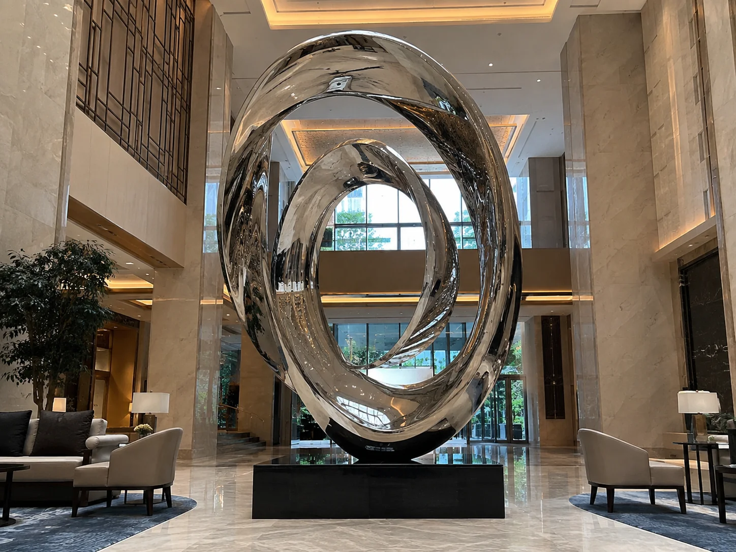 Custom mirror polished stainless steel sculpture installed in a luxury hotel resort lobby