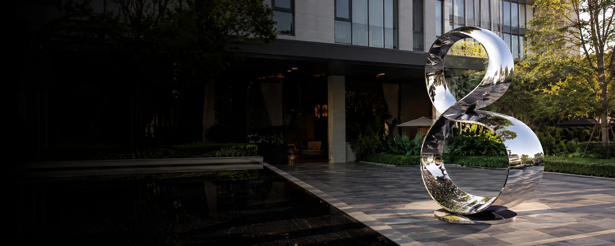 Custom stainless steel sculpture installed at luxury architectural project entrance